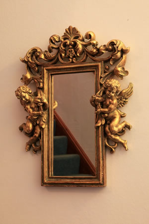 Gilt mirror with cherubs.